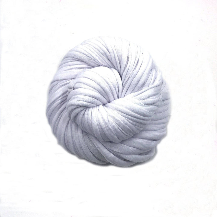 Single skein of cotton t-shirt yarn in colorway white in front of a white background.