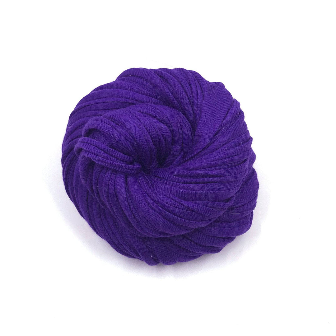 single skein of cotton t-shirt yarn in colorway ultraviolet in front of a white background. 
