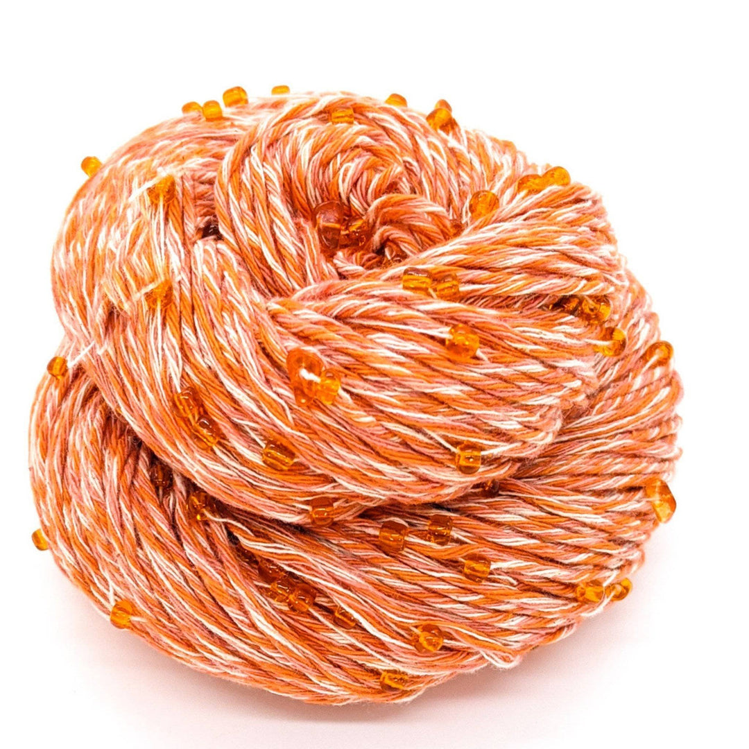 Orange and white yarn with orange beads and crystals throughout.
