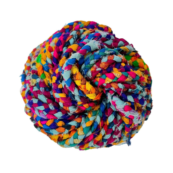 single skein of braided ribbon yarn multicolor in front of a white background.