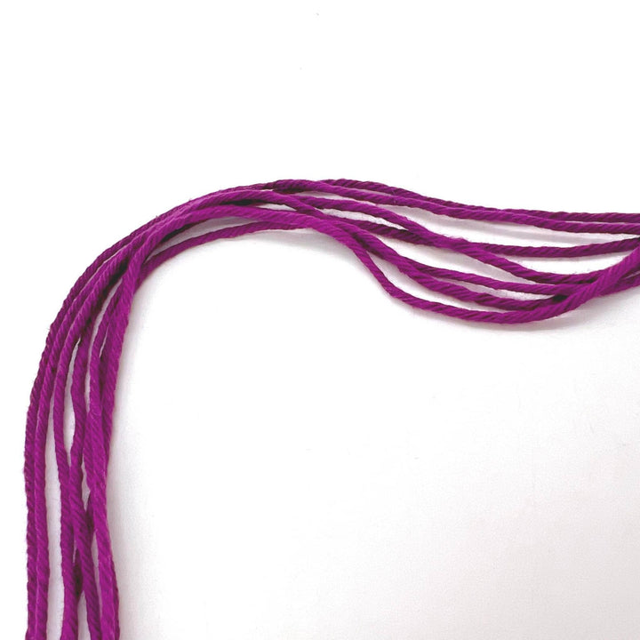 7 strands of purple circulo cotton maxcolor 4-4 in front of a white background