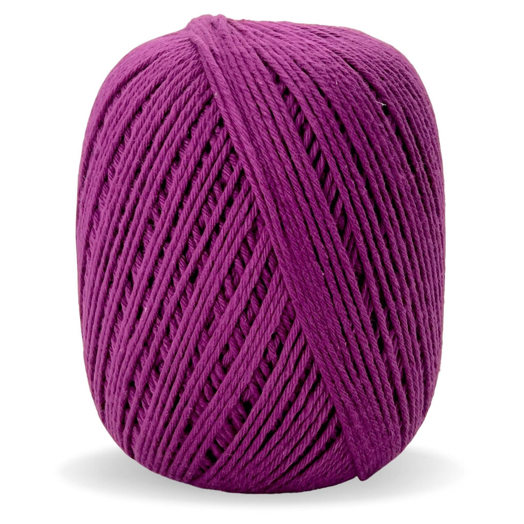 Purple cotton yarn in front of a white background.