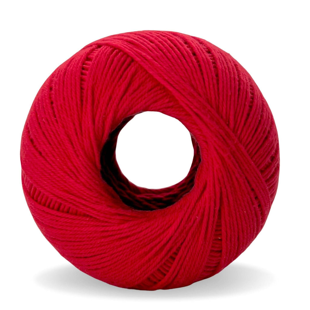 Skein of raspberry red cotton yarn in front of a white background.