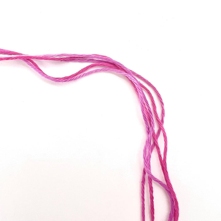 Strands of circulo whoopee lychee in front of a white background to show detail.