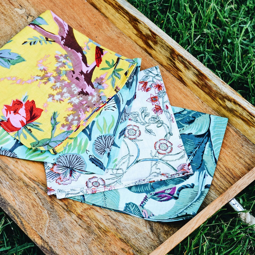 Assorted cloth napkins laid out on a wooden tray