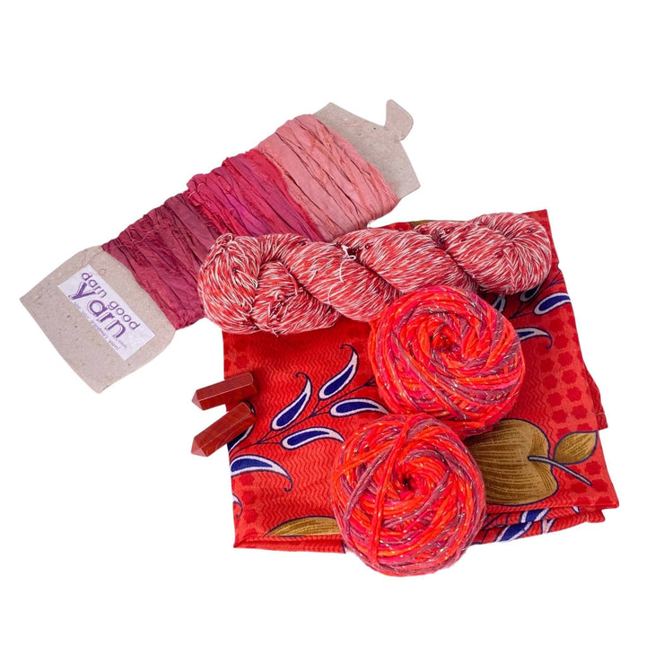 Jasper energy bundle with all items showing in front of a white background. 2 jasper crystals, 2 skeins sparkle worsted weight silk, 1 skeins chakra beaded cotton yarn, 3 color sari silk ribbon sample card, and coordinating furoshiki.