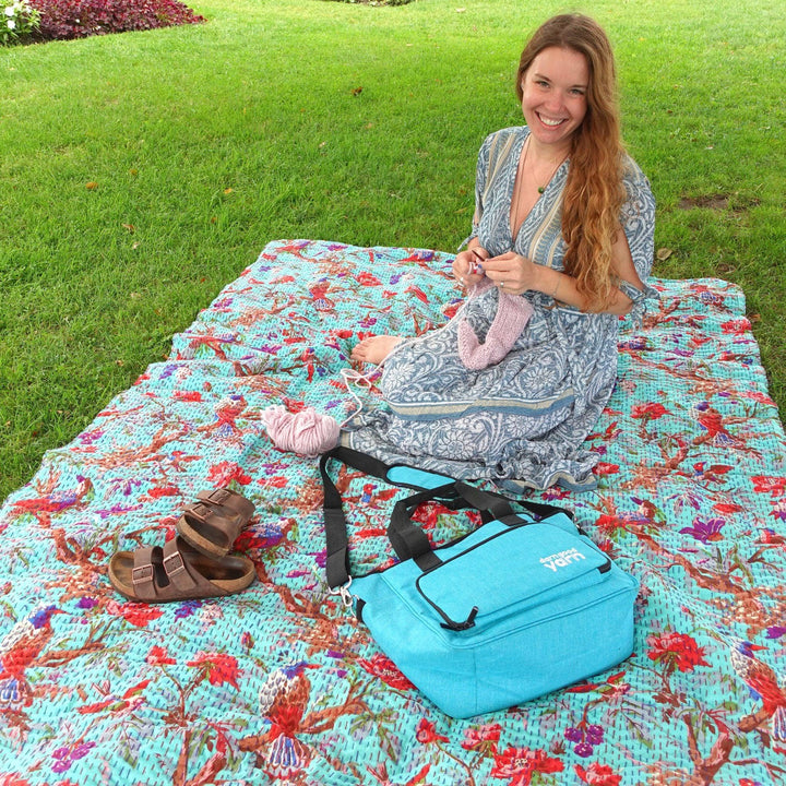 Nicole crafting with Teal Storage bag on a kantha blanket