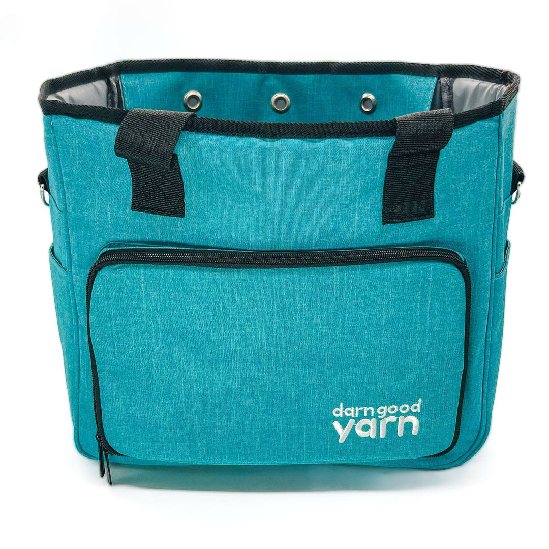 A teal crafters storage bag with the darn good yarn logo on a white background.