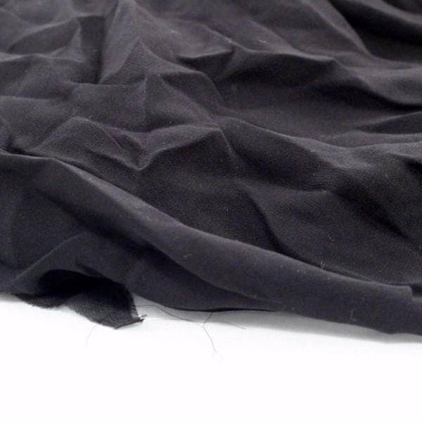 Black crinkle chiffon fabric folded on a white background