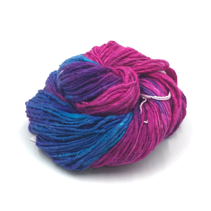Silk roving yarn donut ball in Cupcake (pink, purple, and blue) on a white background