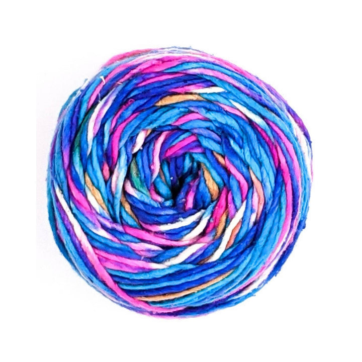 cake of worsted weight silk roving yarn in the colorway phenomena (blue, pink, white, tan) in front of a white background.
