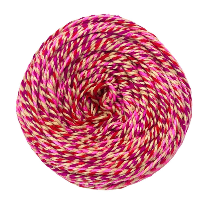 Skein of darn good twist sport weight silk in the colorway pomegranate fizz in front of a white background. 2 ply recycled silk marled pomegranate red and variegated Yellow and pink.