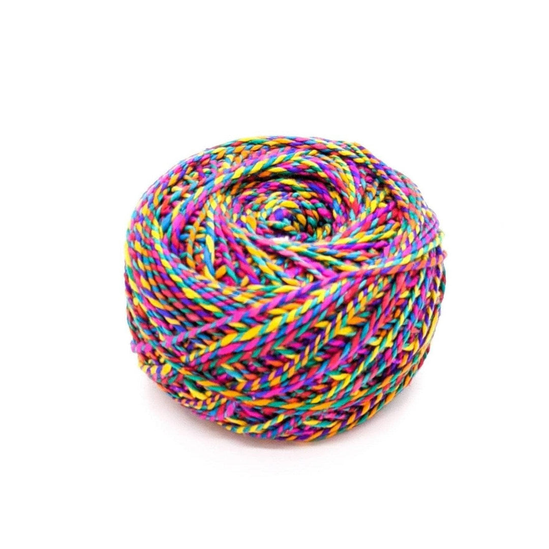 Darn good twist sport weight yarn in the color way twisting rainbow. Pink, blue, orange, green, yellow marled yarn in front of a white background.