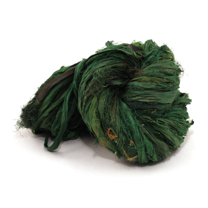 A skein of green ribbon yarn on a white background