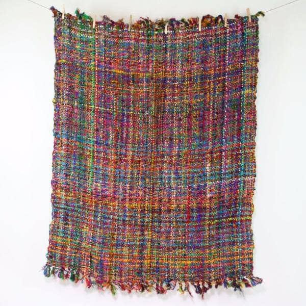 Multicolored woven blanket on a white background