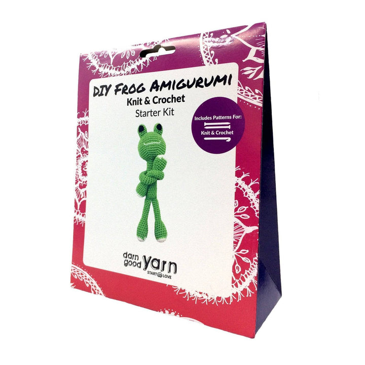 A box with colorful pink borders which says "DIY Frog Amigurumi Knit & Crochet Starter Kit"