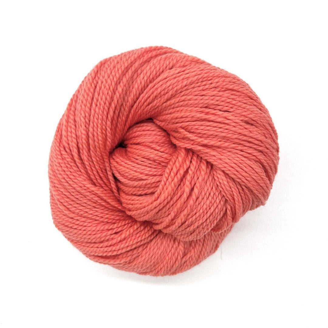 Pink and peach hued yarn on white background