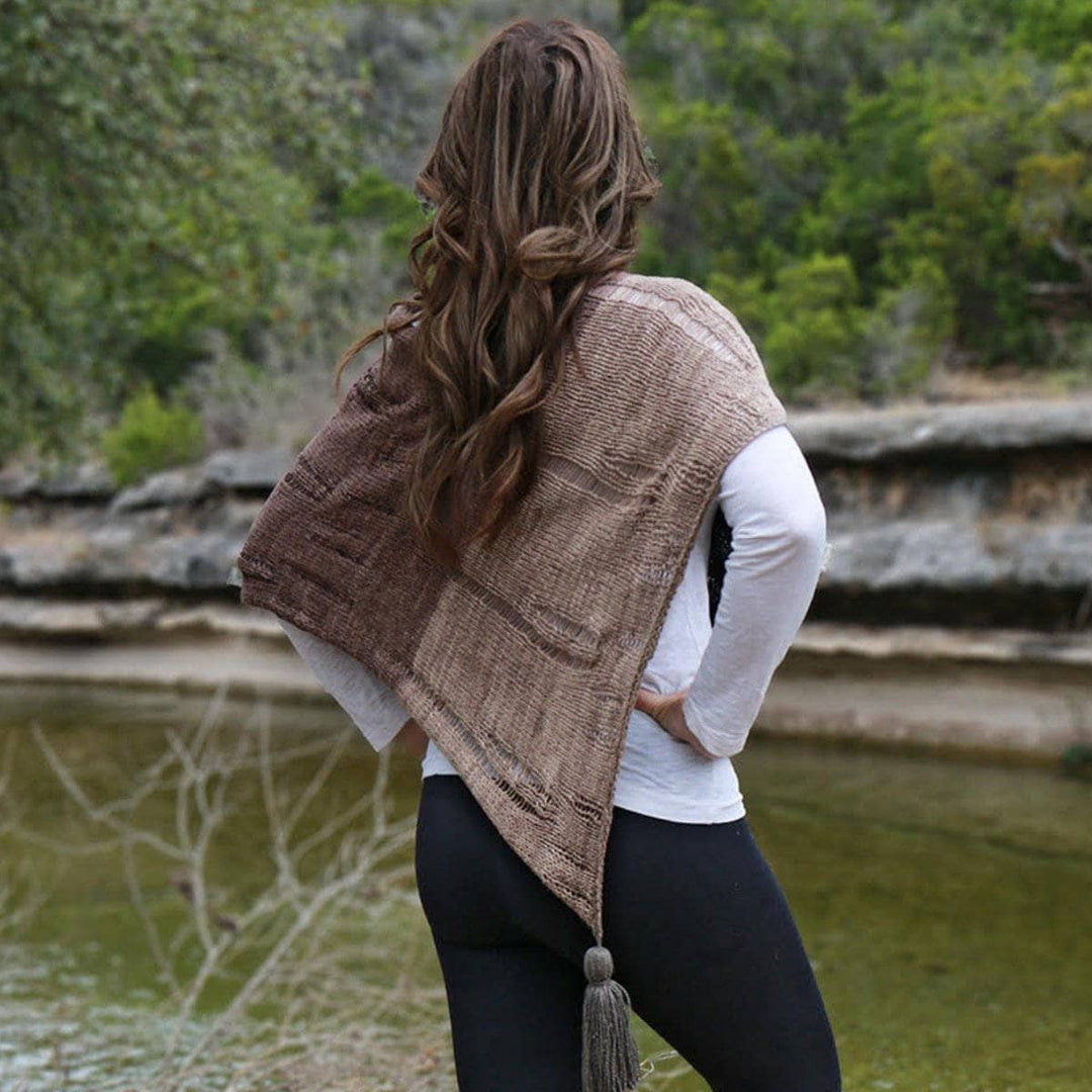 back of a woman wearing a brown poncho