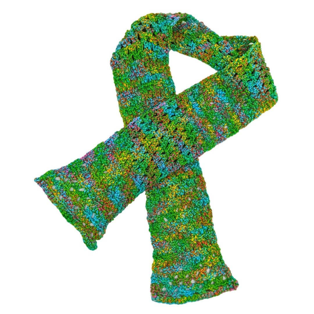 crochet version of early spring scarf in front of a white background. 
