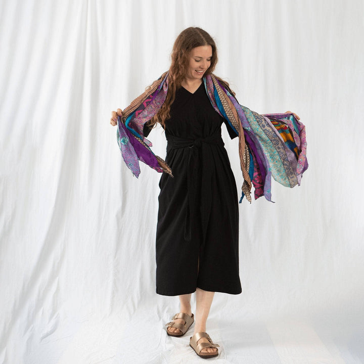 Founder Nicole wearing earth festival scarf in purple in front of a white background.