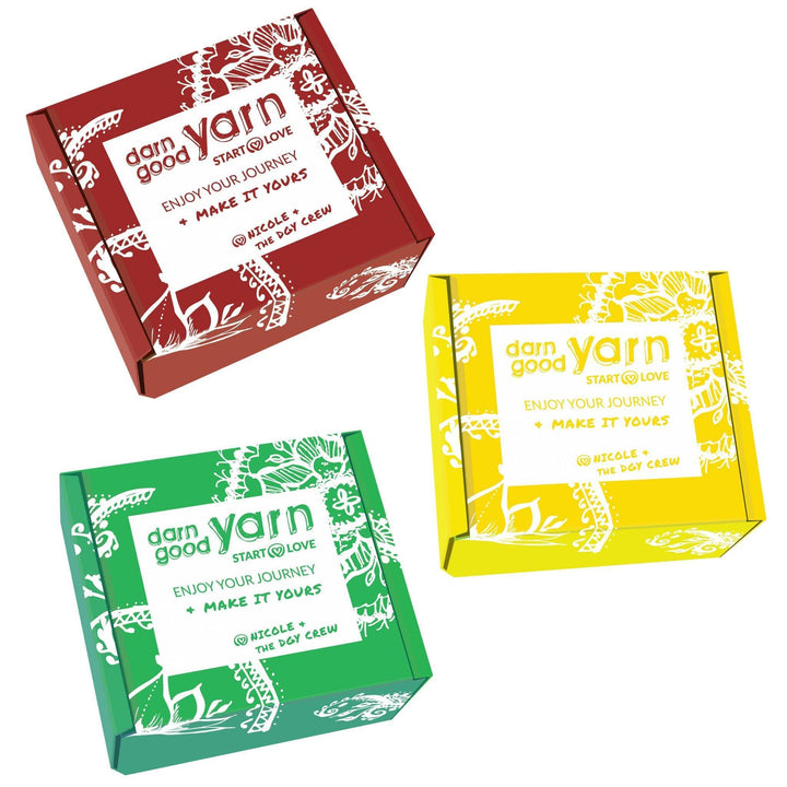 Three Darn Good Yarn Branded Boxes on a white background. The Boxes are in Fall Colors