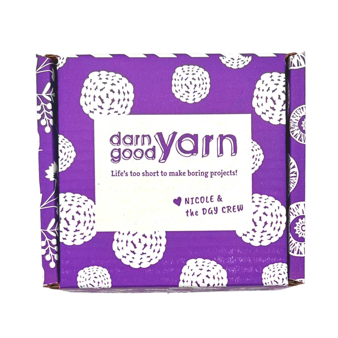 dark purple and white cardboard box in front of a white background.