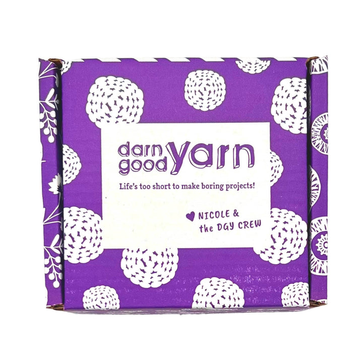 dark purple and white cardboard box in front of a white background.