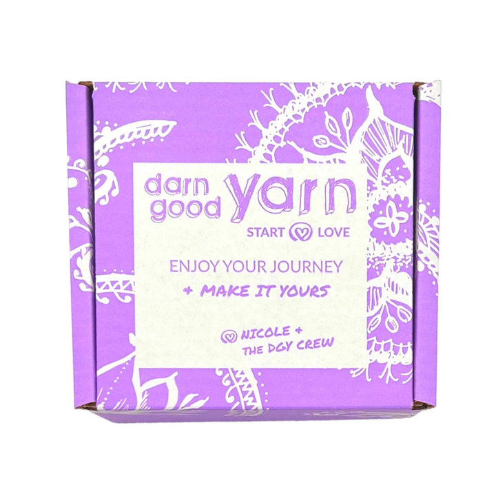 light purple and white cardboard box in front of a white background.