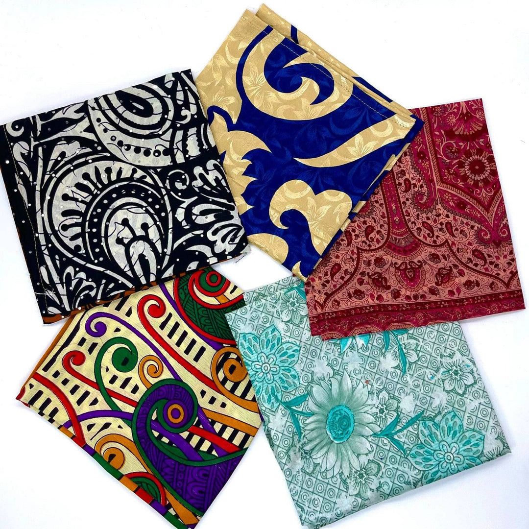 Five reusable sari gift wraps in a circle. Each wrap is a different pattern and colorway