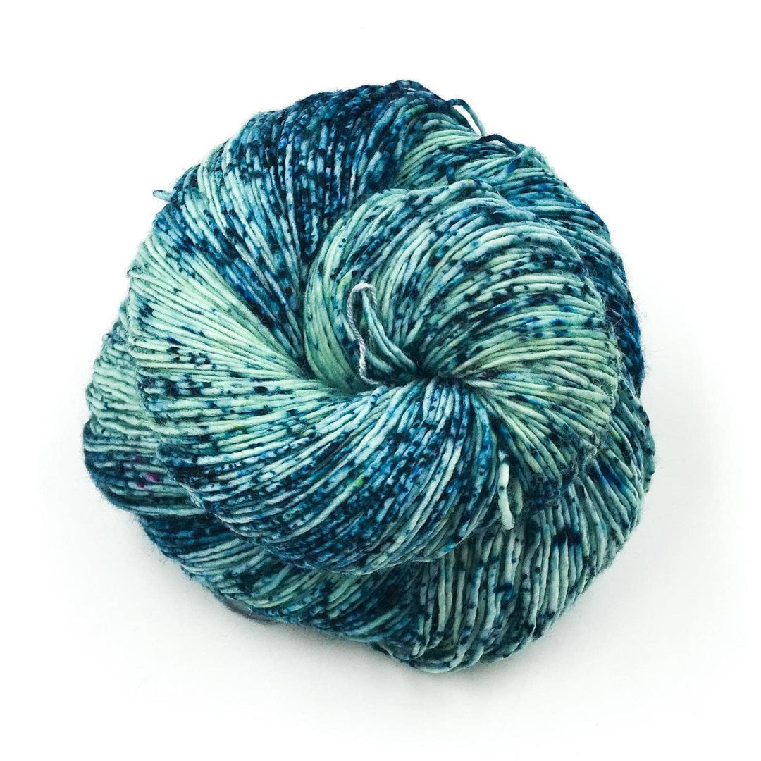 close up of yarn in the color poipu (green, and blue)