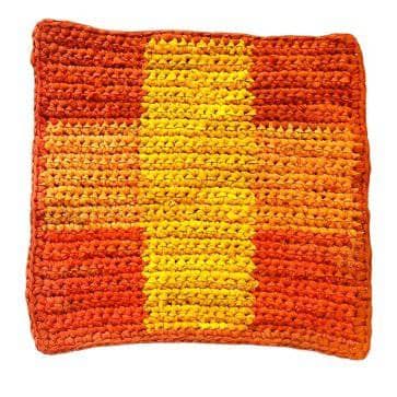 Orange and yellow square placemat sitting on a white background