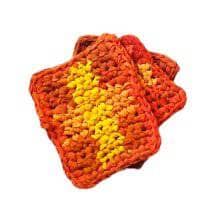 Set of Orange and yellow square coasters sitting on a white background