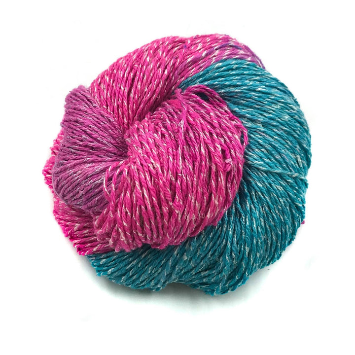 80/20 rule yarn taffy ( pink and blue variegated) in front of a white background.