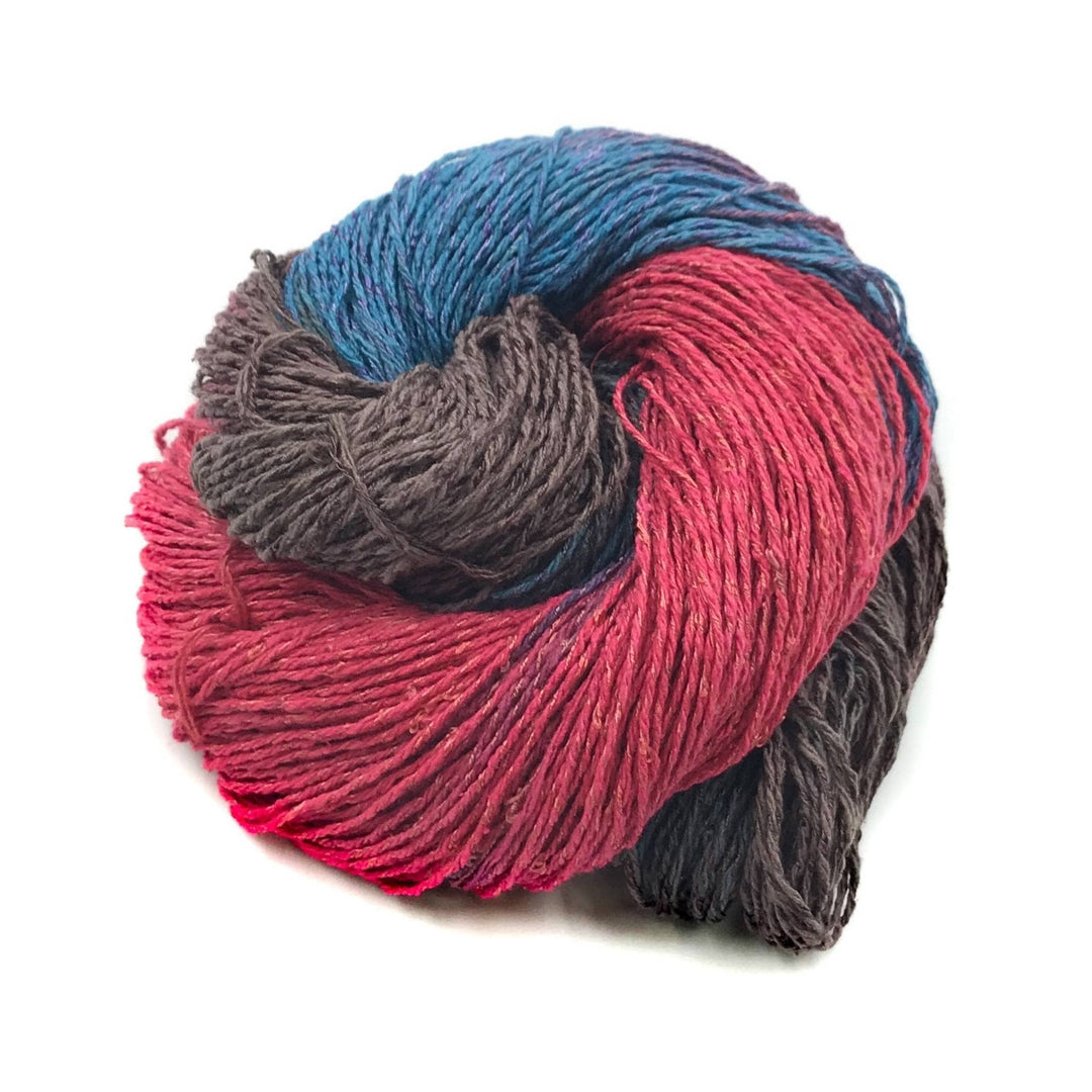 80/20 rile yarn wine daye (grey, red, and blue variegated) in front of a white background.