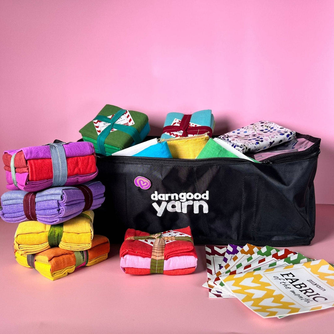 fat quarter storage bag mega bundle with all items showing in front of a bright pink background.