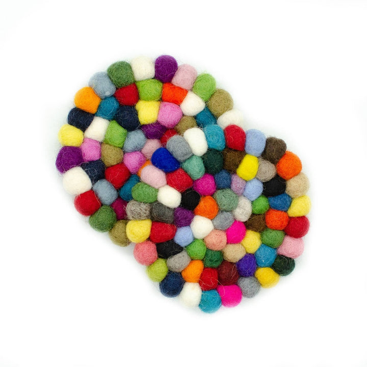 Two colorful felt ball coasters on a white backdrop