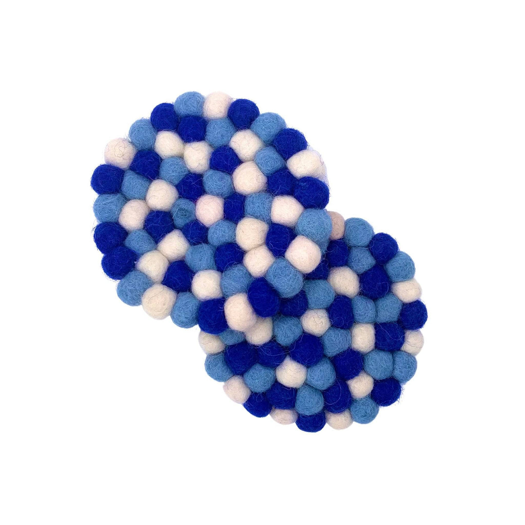 Two Blue and White Felt Ball Coasters on a white background.