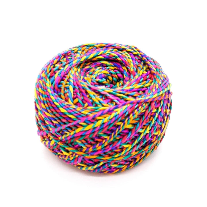 Rainbow color cake on yarn on a white background