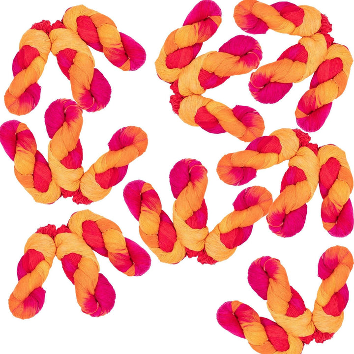 24 hanks of lace weight silk color surge in front of a white background. Color surge is variegated yellow, orange, magenta and red.