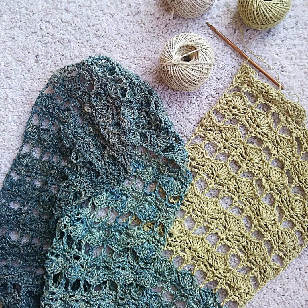 close up of green and beige crochet scarf