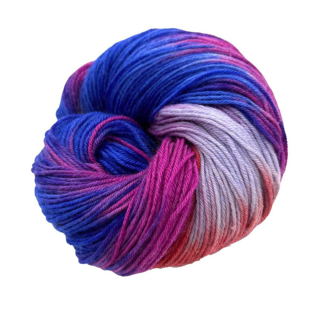 Fingering Weight Superwash Merino and Cashmere Blended yarn on a white background with dark blue, purple, pink, red, and light purple strands of yarn. 