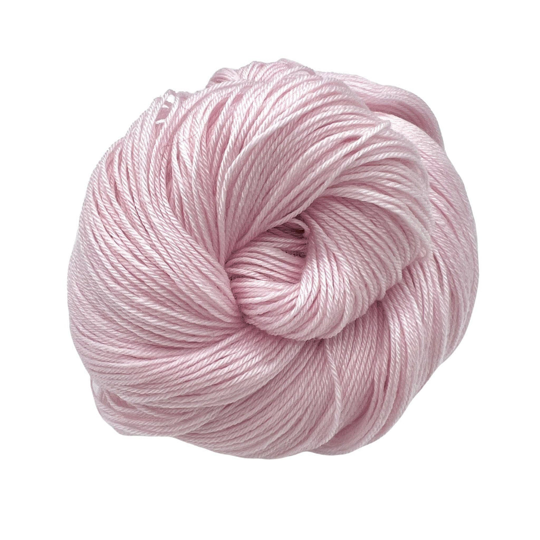 Pink hued yarn on white background