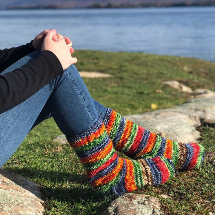 Feet of model outside wearing rainbow Fleece Lined Wool Socks