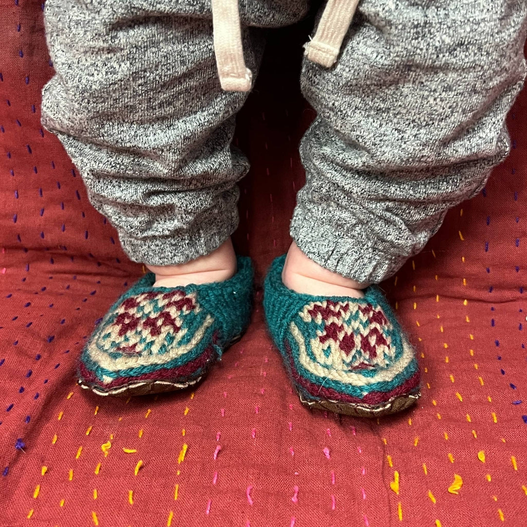 Baby Model wearing the folklore handmade slippers.