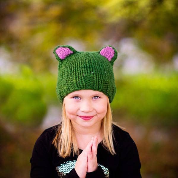 Kid smiling wearing a Forest Friends Wool Hat outdoors