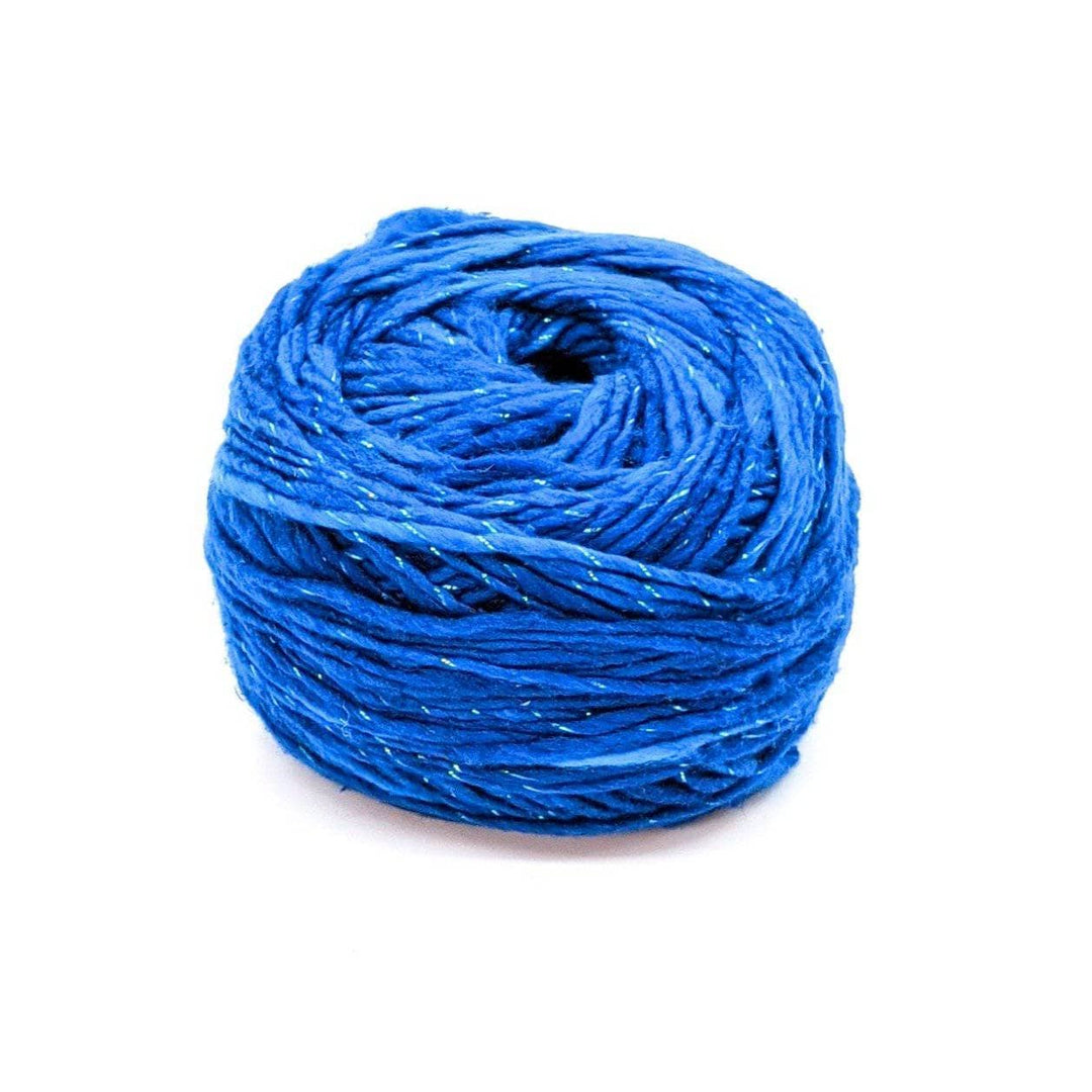single cake of sparkle worsted weight silk in colorway classic blue in front of a white background.