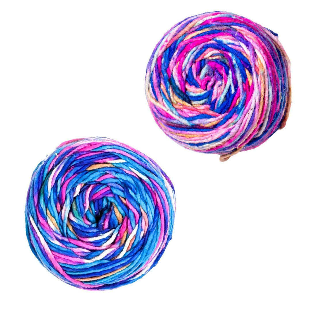 2 cakes of silk roving worsted weight yarn in colorway phenomena in front of a white background.
