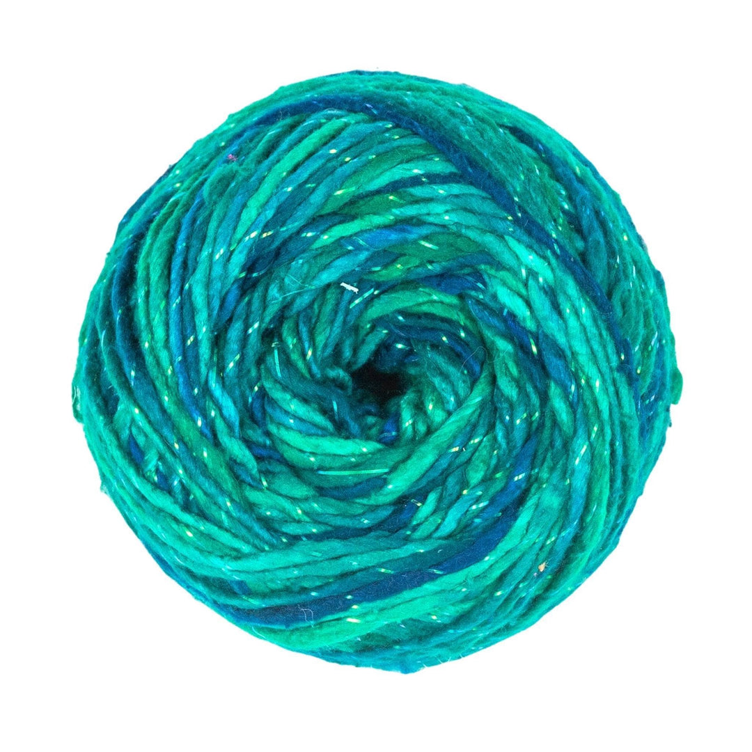Sparkle worsted weight silk enchanted forest ( green and blue variegated) in front of a white background.