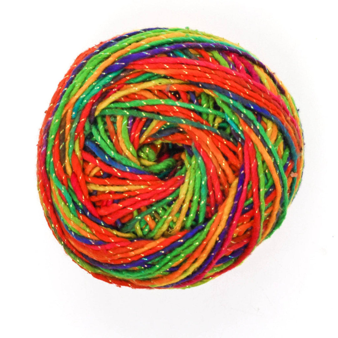 Skein of worsted weight silk yarn in rainbow colorway with sparkle throughout in front of a white background.