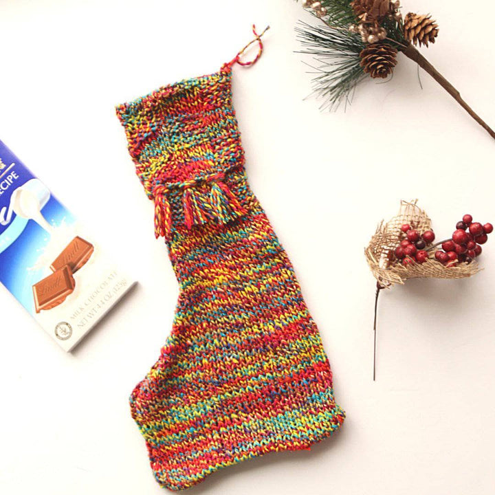 a fun and unique red, yellow, blue, brown orange stocking on a white background